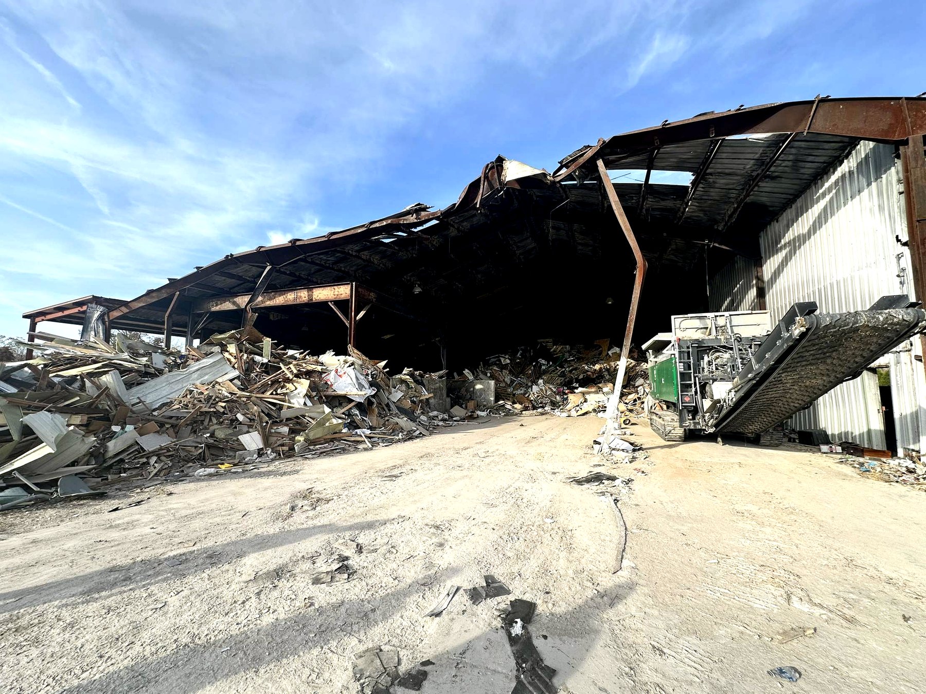 Damaged building exterior with debris during cleanup and demolition work