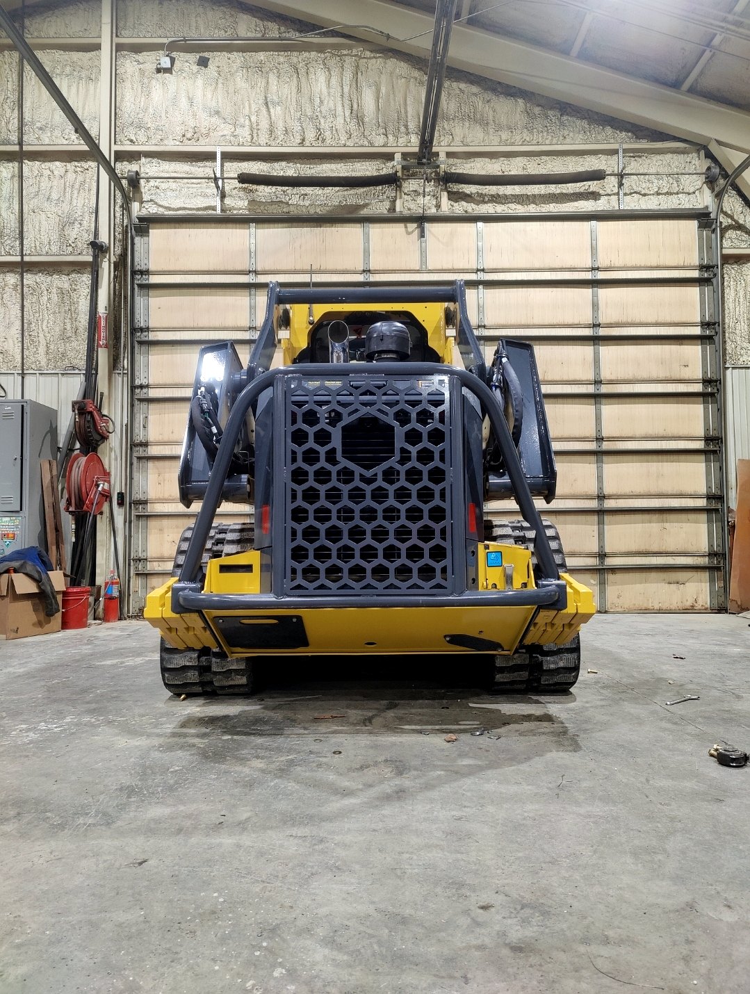 Rear view of a fabricated equipment attachment in a shop
