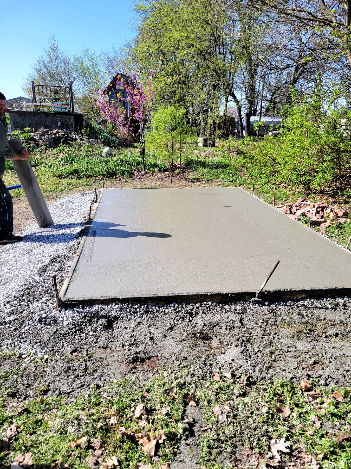 Finished concrete walkway flatwork beside a landscaped building exterior