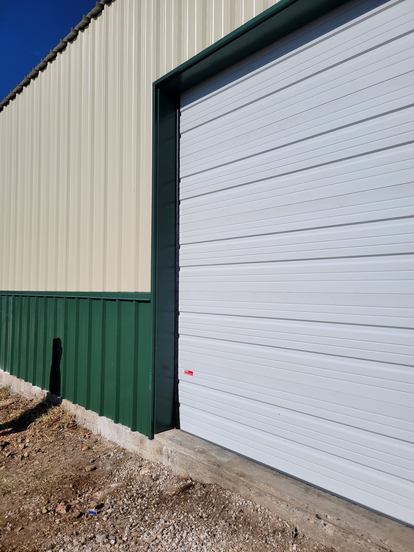 Overhead door and metal siding detail on a commercial building exterior